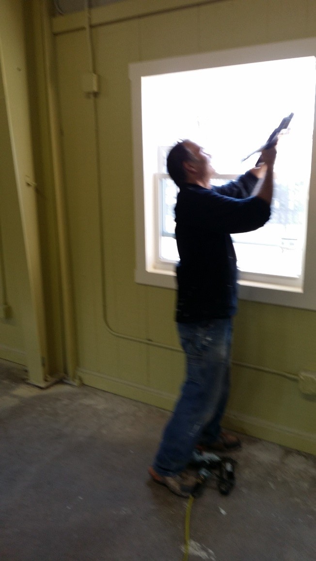 Kevin installing trim around the windows